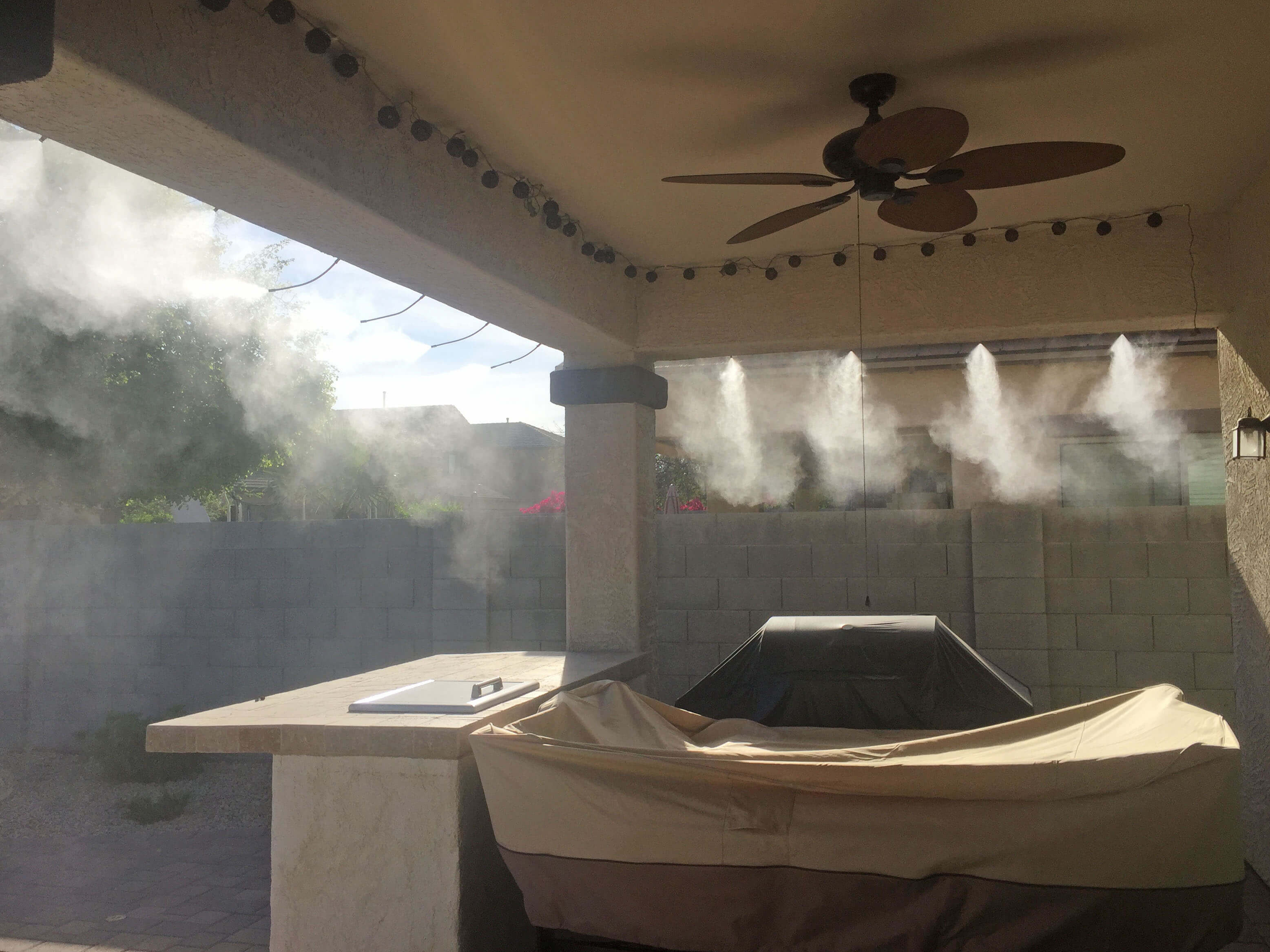 Sunsplash misting system on backyard patio